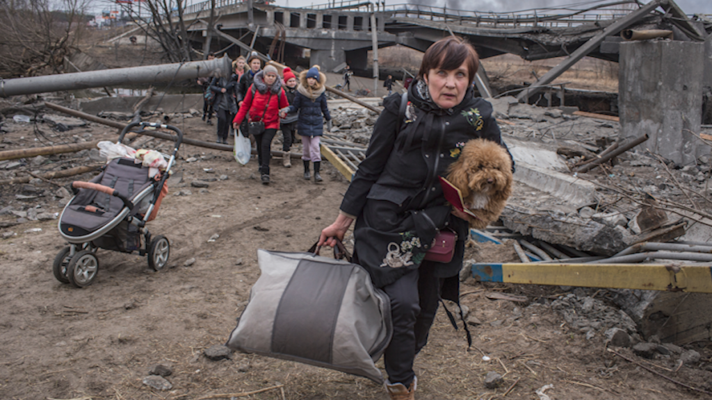 Watch: In Freezing Cold, Ukrainians Flee Capital Kyiv Over Bombed-Out Bridge